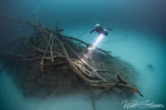 Diver hovering above a breakdown pile at the bottom of Cenote. Mexico